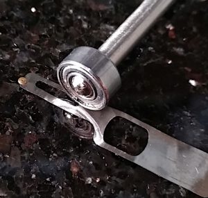 Rolling a Minox shutter blade on a granite base